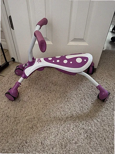 Slightly used purple scramble bag folding bike ride on toy trike bicycle kids on